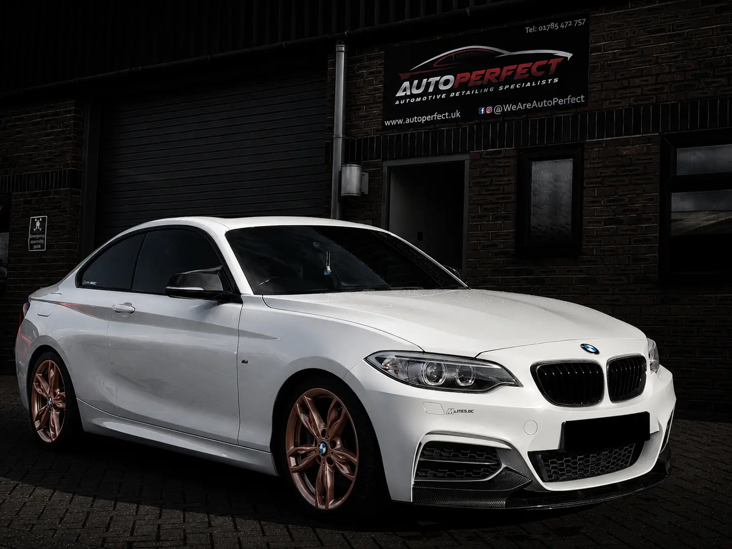 White BMW with refurbished bronze alloy wheels outside the AutoPerfect unit in Stone, Staffordshire