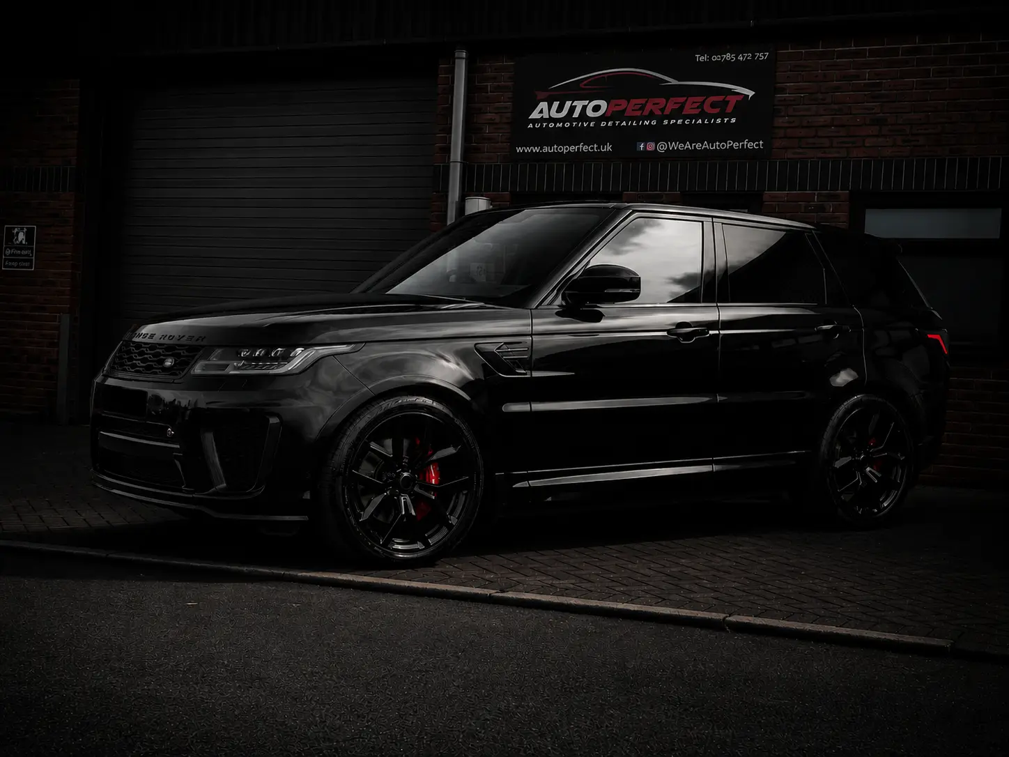 Black Range Rover Sport with black alloy wheels and red brake calipers outside the AutoPerfect unit in Stone, Staffordshire