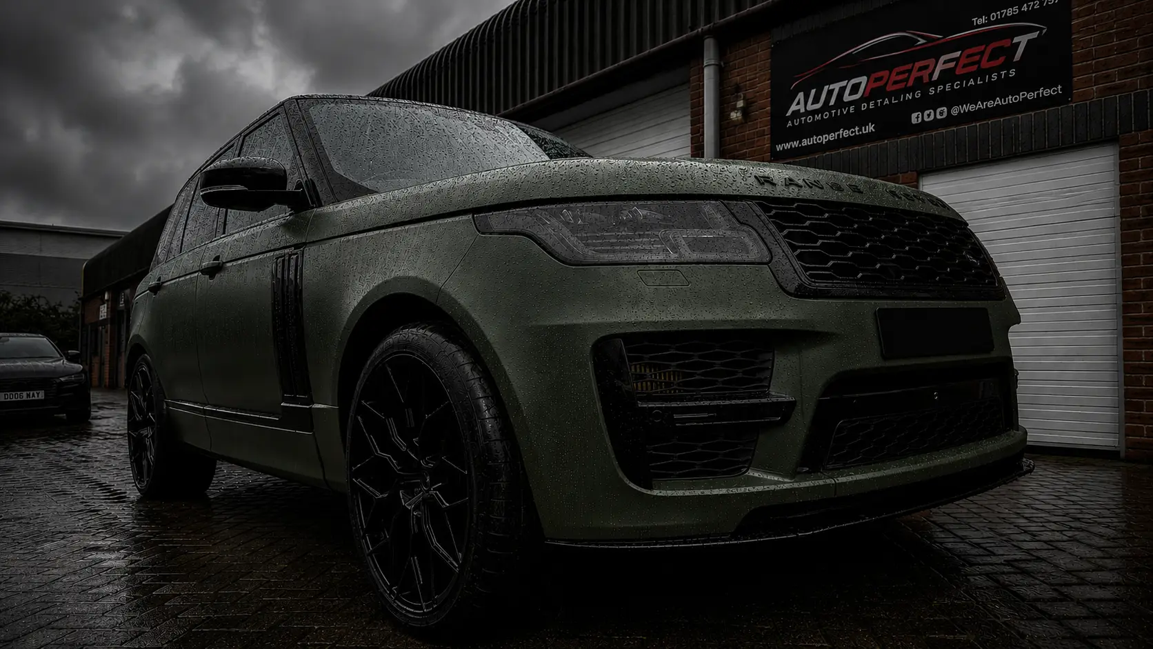 Range Rover wrapped in matte military green with black alloy wheels outside the AutoPerfect unit in Stone, Staffordshire