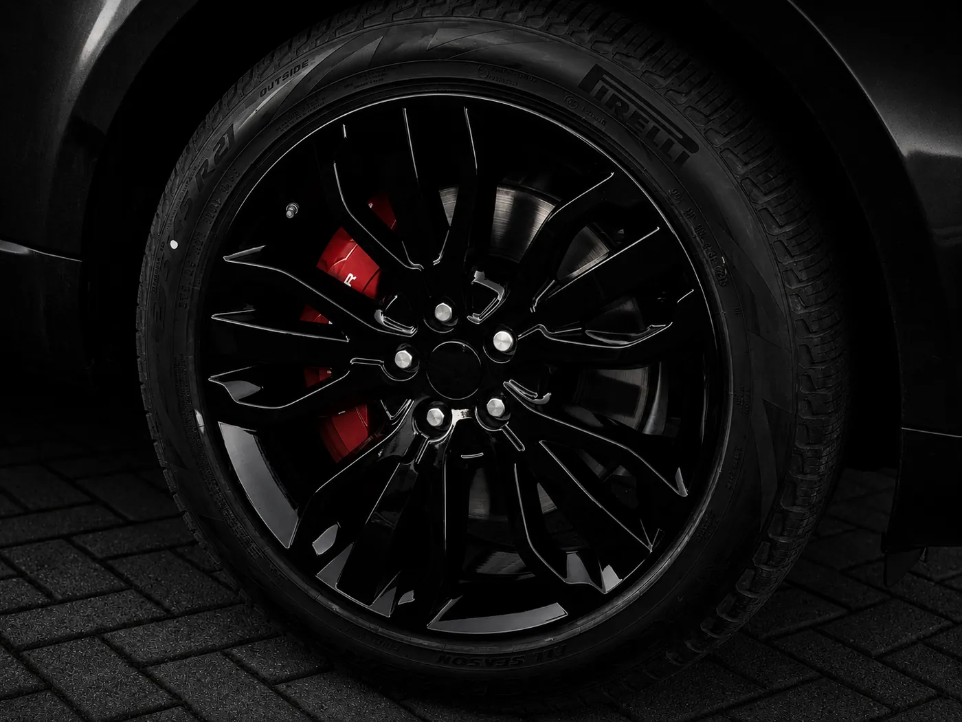 Gloss black alloy wheels with red brake calipers refinished in-house at AutoPerfect, Stone